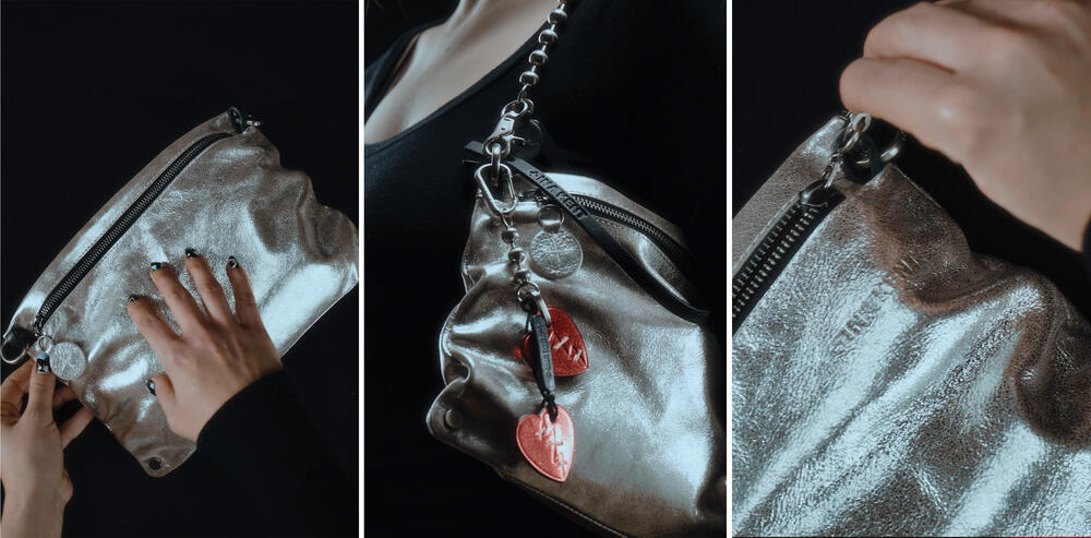 Three close-up views of the metallic silver INA KENT clutch bag with a zipper, shown with a hand, a shoulder strap, and red heart-shaped charms attached.