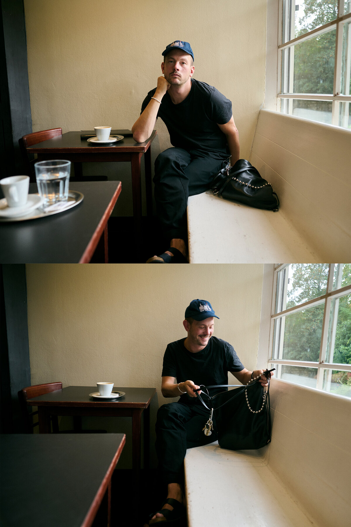 A person in black clothes and a blue cap sits by a window in a café, first looking thoughtful, then smiling while retrieving items from a black bag.