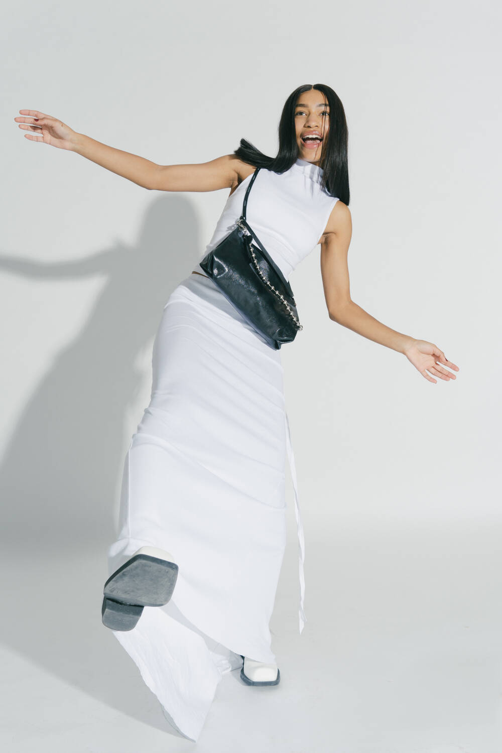 Woman balancing towards the camera with an ORNAMENT ed.2 which she carries crossbody around her body