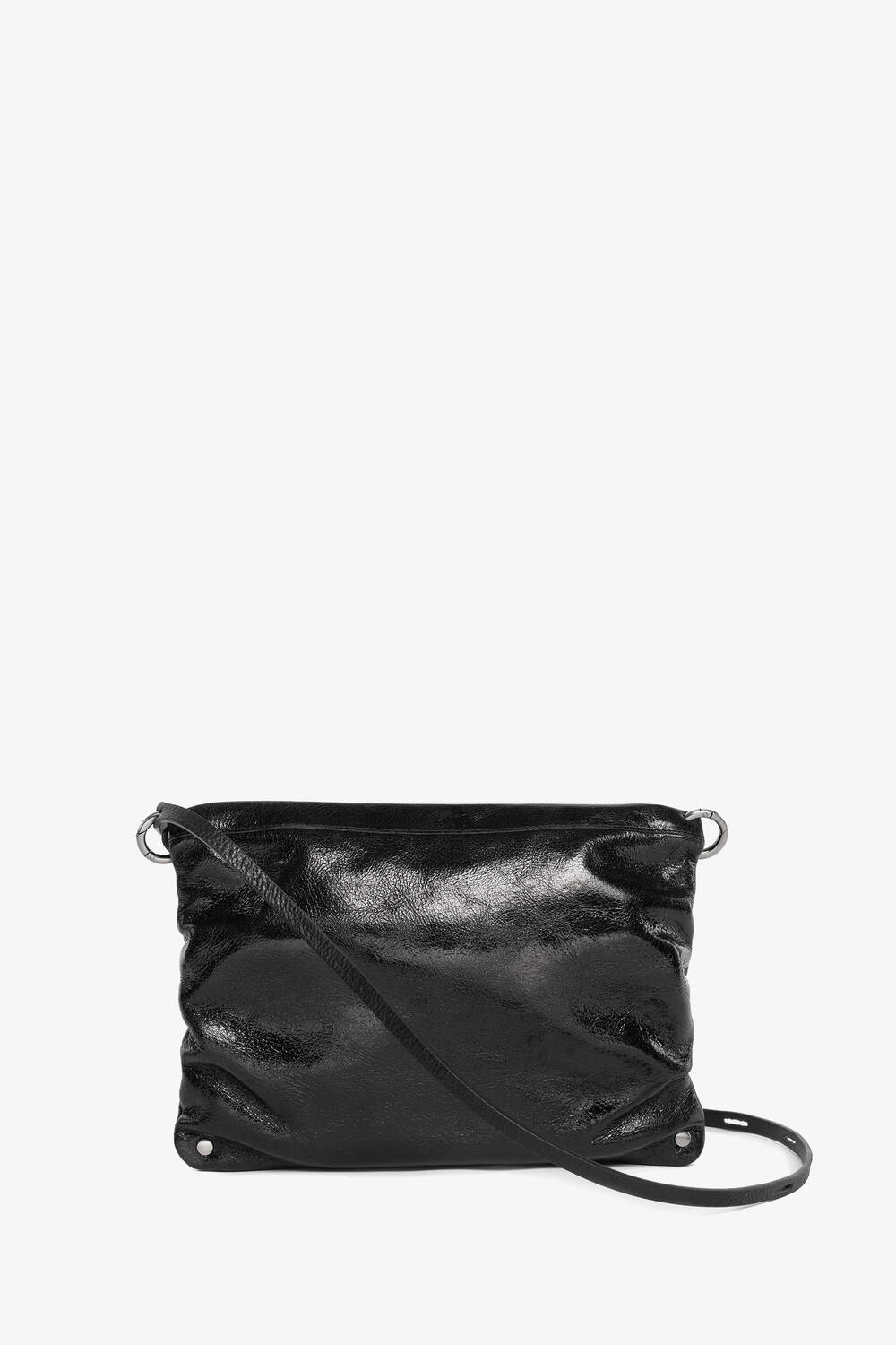 The black, glossy leather crossbody bag by INA KENT features a simple design and an adjustable strap, all set against a clean white background.