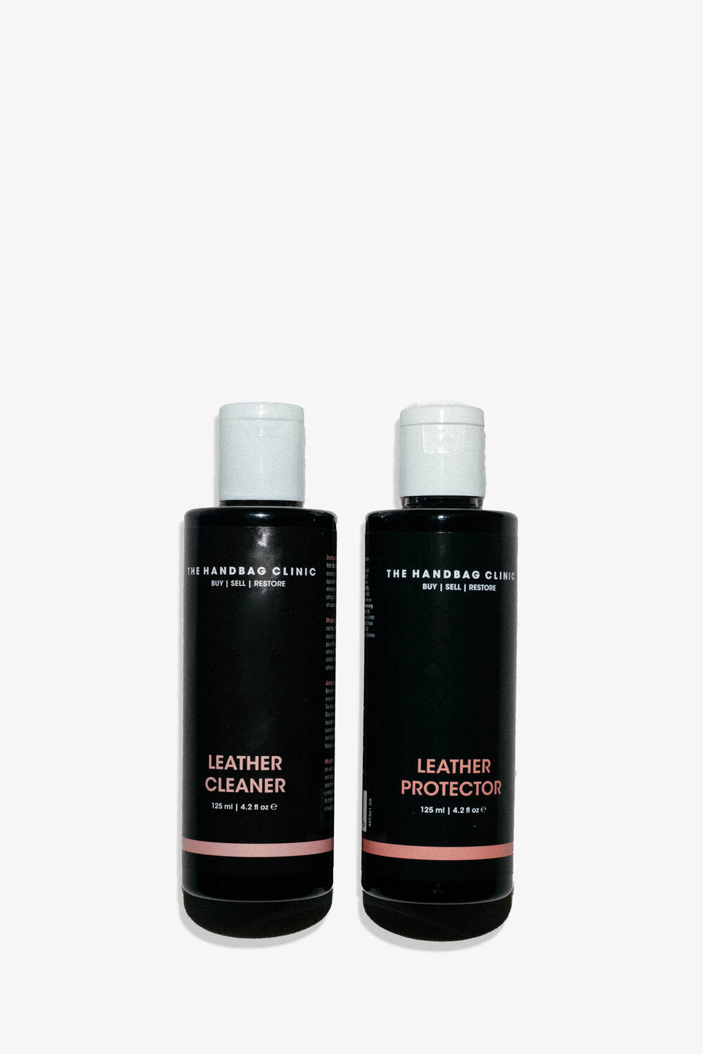 Zwei schwarze Flaschen mit den Aufschriften "Leather Cleaner" und "Leather Protector" von The Handbag Clinic, die perfekt für INA KENT-Taschen geeignet sind, stehen nebeneinander vor einem weißen Hintergrund.