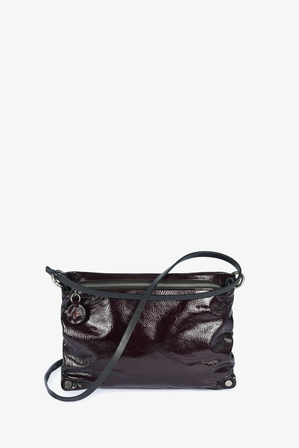 A small, glossy dark burgundy INA KENT crossbody bag with a zipper closure, silver hardware, and a thin adjustable strap, displayed against a white background.