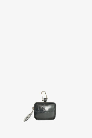 A small black leather pouch by INA KENT, featuring a zipper, carabiner clip, and attached keychain.