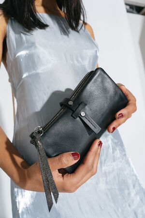 Woman holds a Chiefy ed.1 purse with both hands and shows it to the camera 