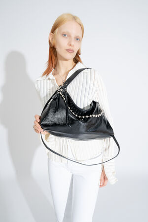 INA KENT bag DINKUM ed.2 in patent ink black,l worn over the shoulder, combined with the chain strap BALL'N'CHAIN ed.1