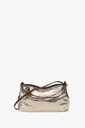 The INA KENT metallic gold handbag features a chic brown leather strap and a unique round decorative charm, merging style with elegance.