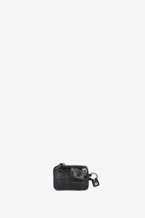 A small black leather key pouch by INA KENT with a zipper closure and metal keyring attachment, displayed on a plain white background.