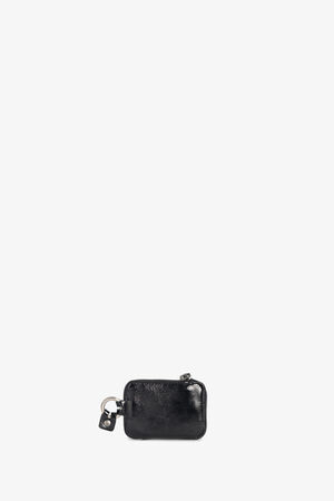 A small black leather pouch by INA KENT with a zipper and keyring attachment, placed against a plain white background.