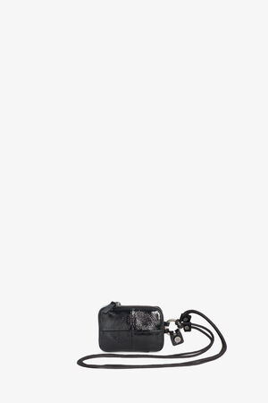 Small black leather crossbody case by INA KENT, featuring a zipper closure and attached strap, displayed against a plain white background.