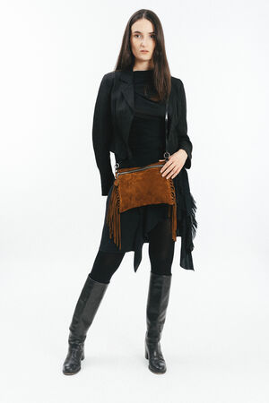 Woman standing facing forward wearing a black outfit with a brown suede INA KENT fringe shoulder bag and knee-high black boots, against a white background.