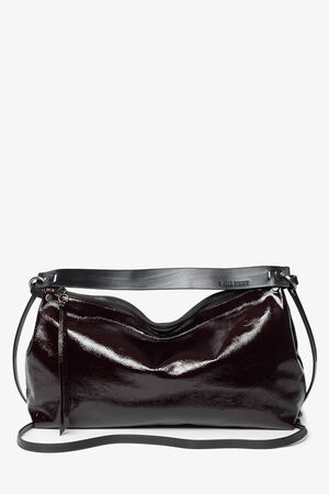 A rectangular, dark burgundy patent leather shoulder bag by INA KENT with a visible zipper, two straps, and a minimalistic design set against a white background.
