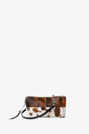 Small rectangular INA KENT clutch with a cowhide pattern, zipper closure, and a black leather wrist strap, displayed against a plain white background.
