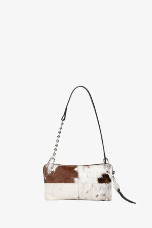 Small rectangular INA KENT clutch with a cowhide pattern, zipper closure, and a black leather wrist strap, displayed against a plain white background.