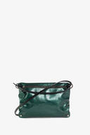 The INA KENT shiny green leather crossbody bag, featuring a zipper closure and adjustable strap, is elegantly displayed against a white background.