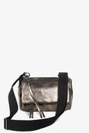 A metallic silver INA KENT crossbody bag with a wide black adjustable shoulder strap and a zipper closure, displayed on a plain white background.