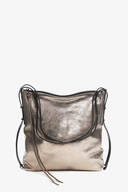 Metallic silver leather INA KENT shoulder bag with a curved zip closure, black adjustable straps, and a decorative leather tassel, displayed against a plain white background.