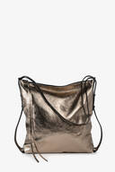 A metallic bronze leather INA KENT crossbody bag with a zipper closure, thin shoulder strap, and decorative leather tassels, displayed against a white background.