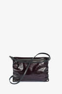 A small, dark burgundy INA KENT patent leather crossbody bag with a zipper closure, silver hardware, and a thin adjustable strap, displayed against a plain white background.