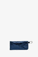 A rectangular, shiny navy blue INA KENT pouch with a silver carabiner clip attached to one corner, set against a plain white background.