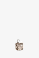A small metallic pouch by INA KENT with a flap closure and a metal clip attached at the top, photographed against a plain white background.
